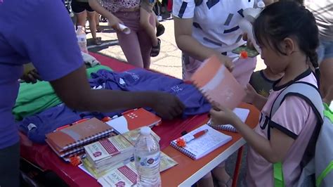 Volunteers in Waltham give away hundreds of backpacks to families in need ahead of school year